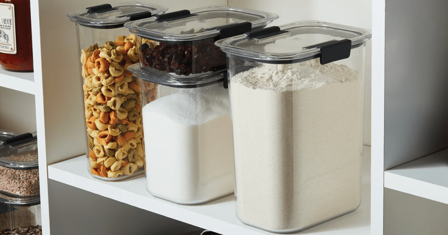 a set of clear food storage containers on a shelf in a pantry