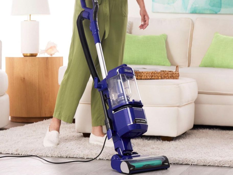 Woman using a Shark Detect Vacuum 