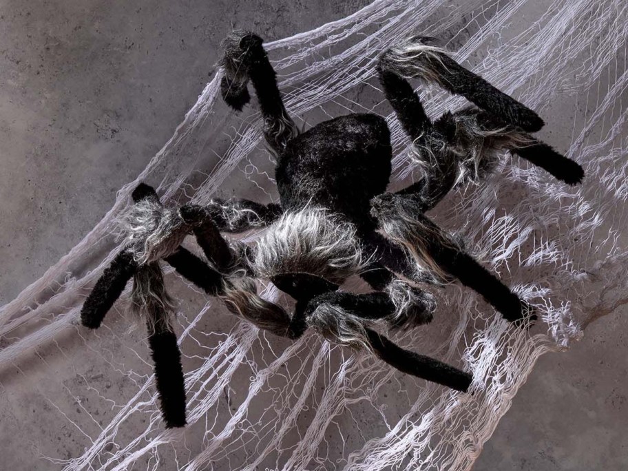 a large black Halloween decor spider in a web