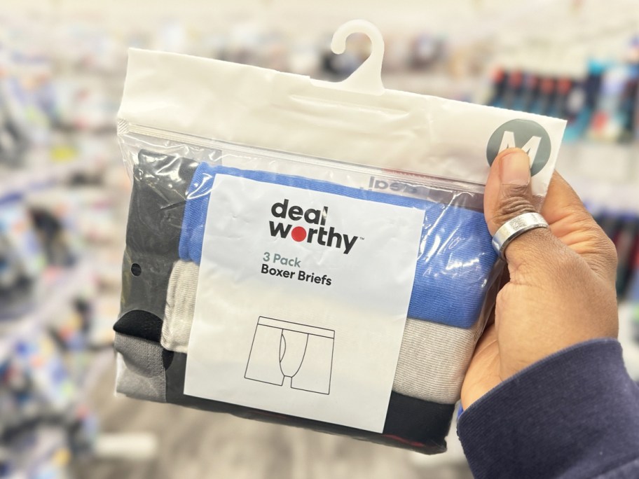 hand holding up a pack of Dealworthy boys boxer briefs at Target