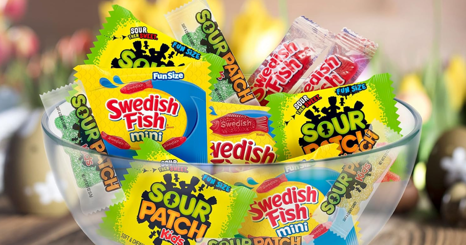 a bowl with individual packs of Easter Swedish Fish and Sour Patch Kids candy