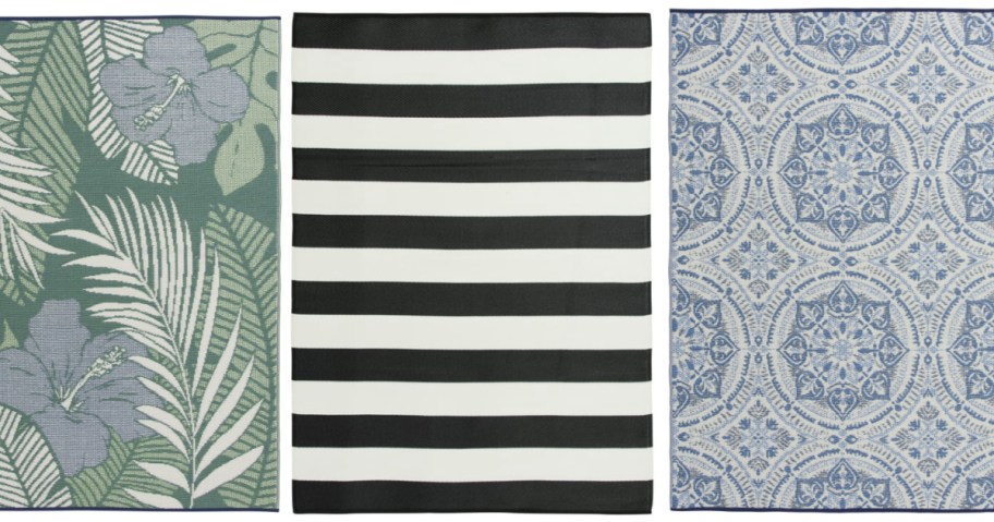 Three outdoor rugs featuring black and white stripes, blue medallions, and a floral print