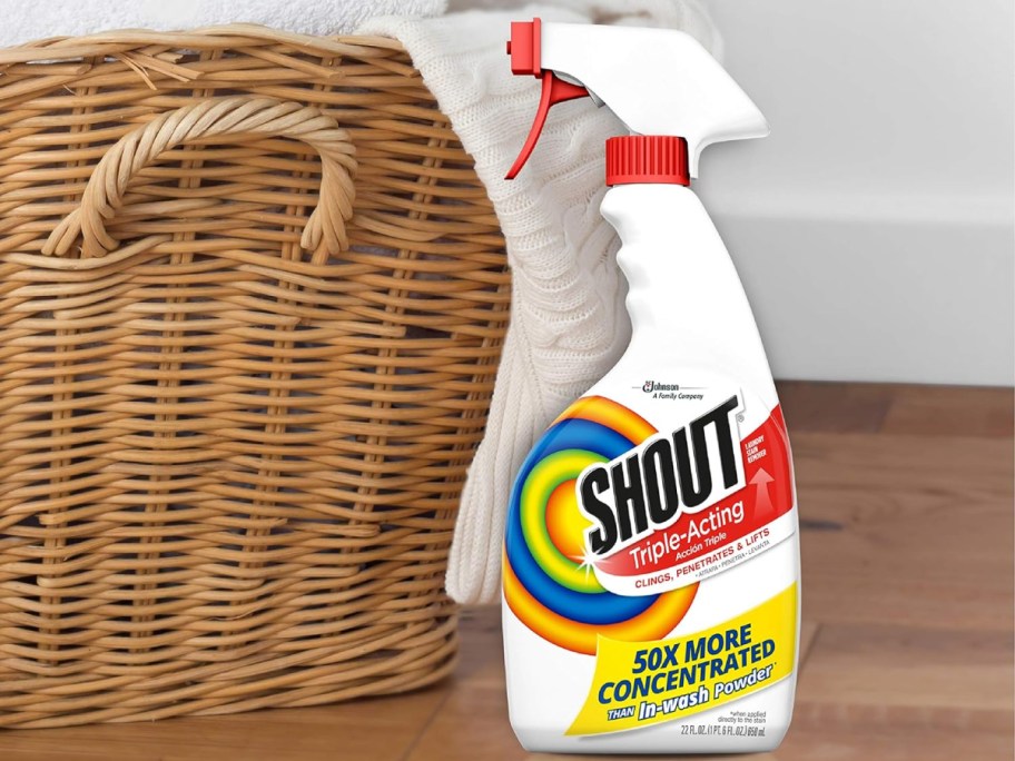 shout stain remover spray next to a laundry basket