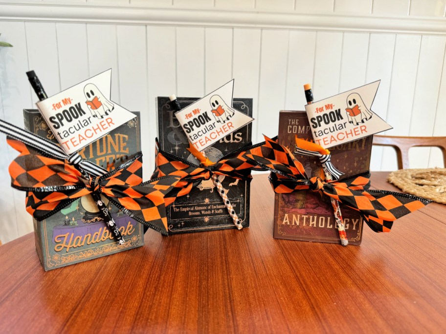 3 wrapped halloween book boxes with teacher tags