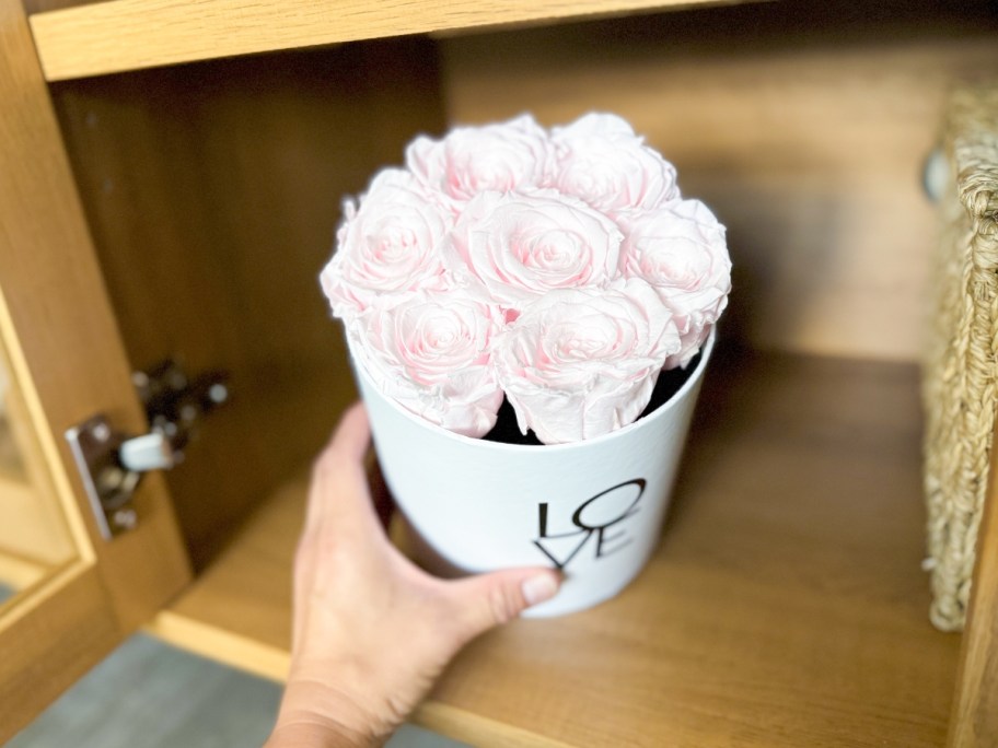 pink roses in a white container