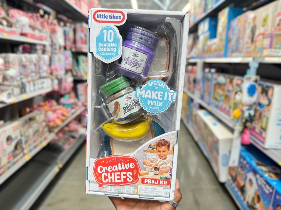 hand holding a box with a Little Tikes Creative Chef Peanut Butter & Jelly Kit playset