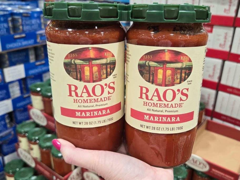 hand holding rao's sauce jars