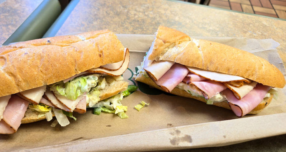 a Subway foot long sandwich cut in half on a table