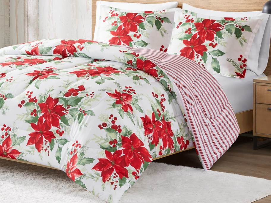 Poinsettia print comforter and shams on bed