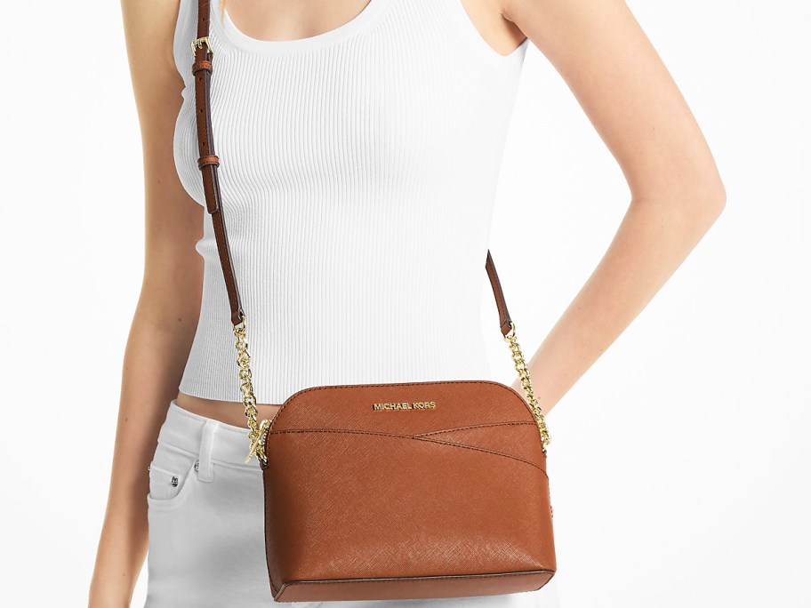 woman in a white outfit with a brown crossbody bag