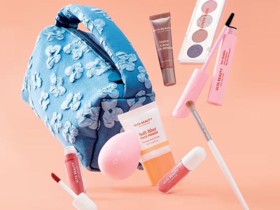 A make up bag suspended in the air with multiple items coming out of it 