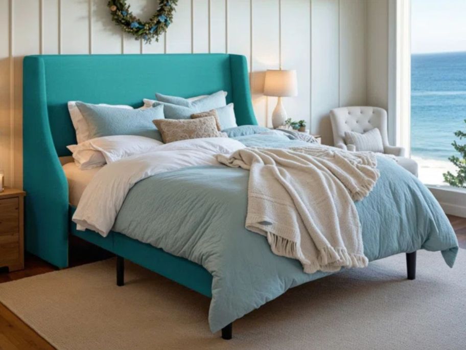 A bedroom with a Mercury Row Bowdoin Upholstered Wingback Queen Platform Bed