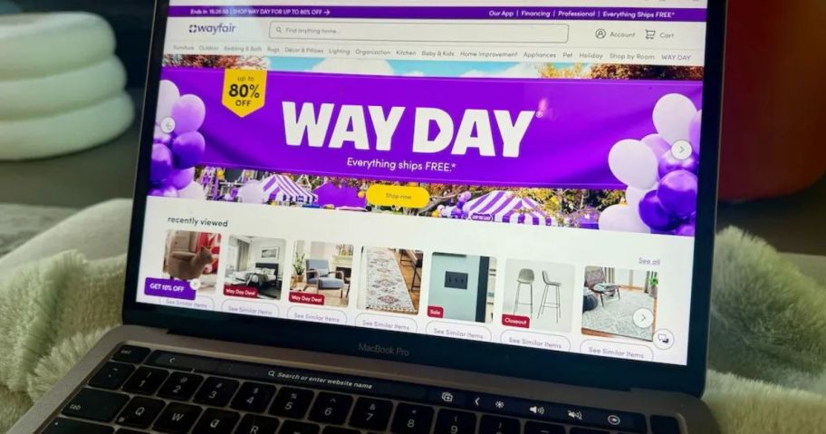 A laptop screen with Wayfair website featuring their Way Day Sale banner