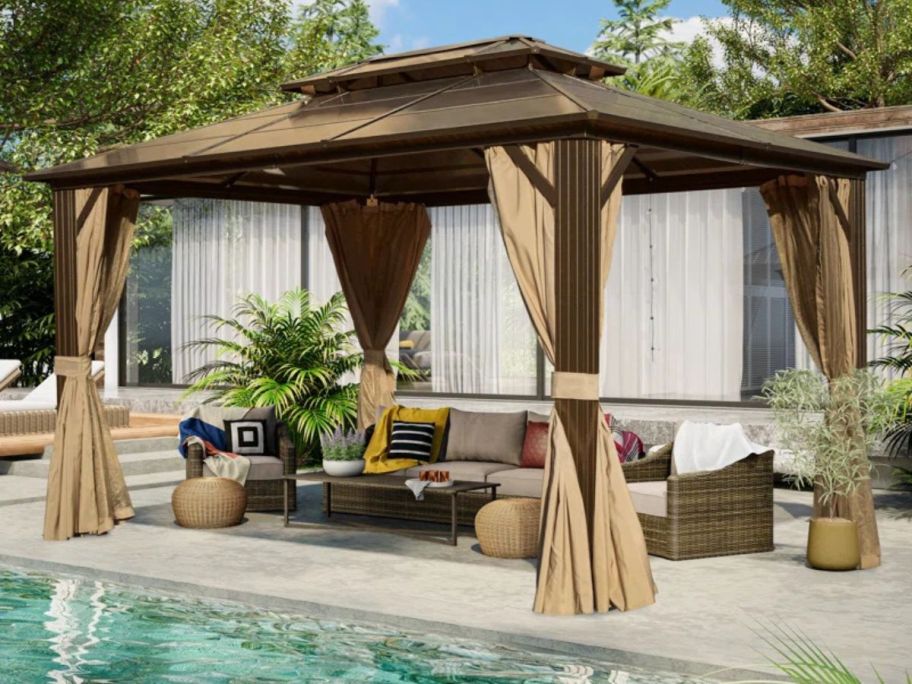 beige and brown gazebo on patio with patio set underneath