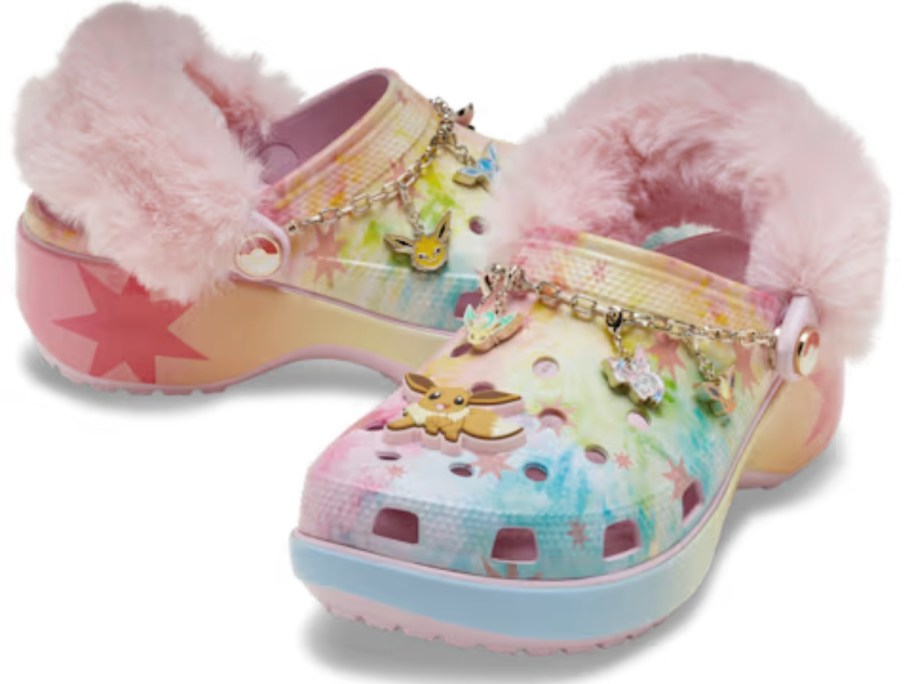a pair of pink, blue, and yellow Pokemon platform Crocs clog shoes with faux fur around the straps