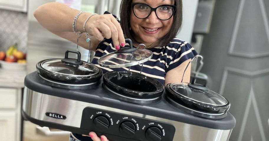 Woman holding a Bella Triple Slow Cooker