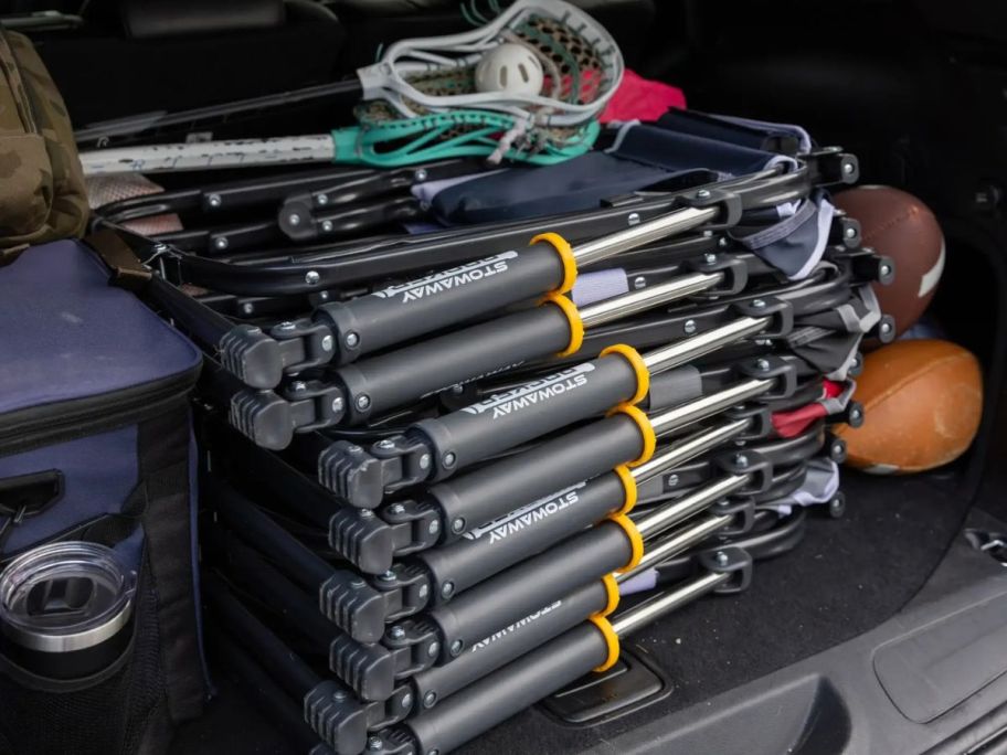 A trunk with several GCI chairs folded and stacked in the back with lacrosse equipment