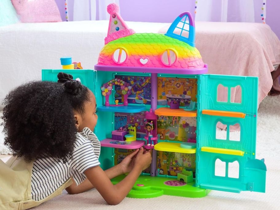 girl playing with Gabby's Dollhouse 14-Piece Celebration Dollhouse