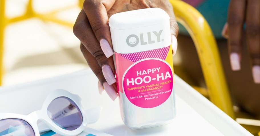 hand grabbing a bottle of OLLY Happy Hoo-Ha Capsules