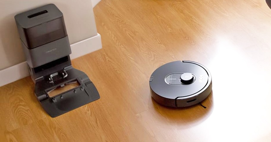 black robot vacuum leaving its self-empty base
