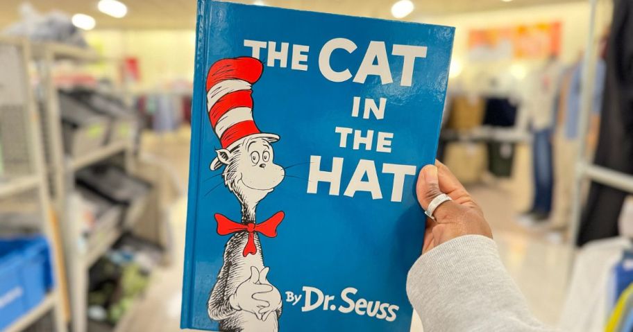 Hand holding The Cat in the Hat Book