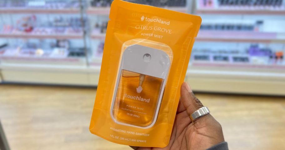 Hand holding a touchland hand sanitizer