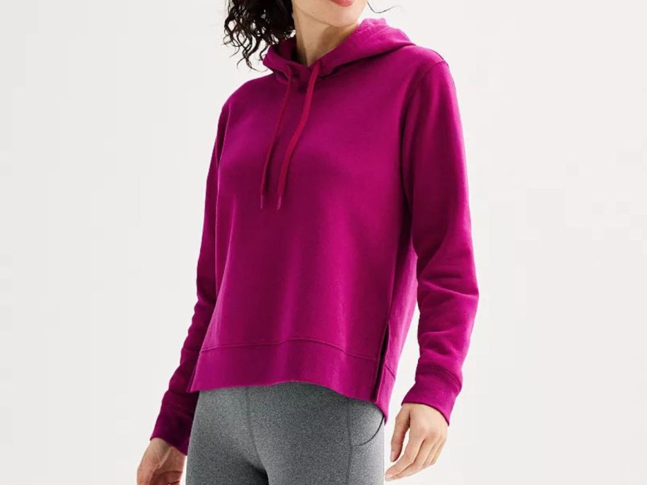 A woman wearing a pink hoodie 