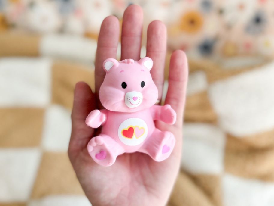 Worlds Smallest Care Bear in the palm of someone's hand