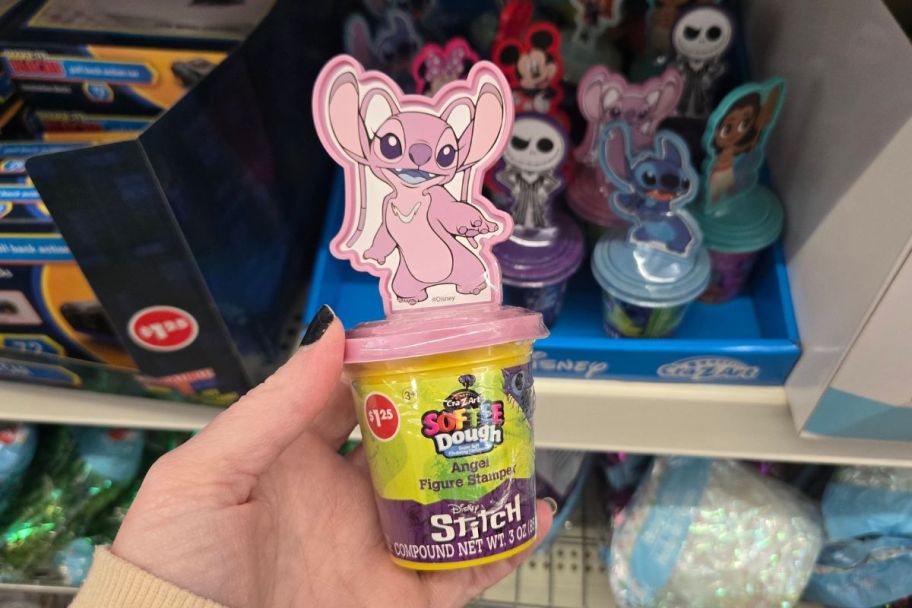 a womans hand holding a softee dough stamper