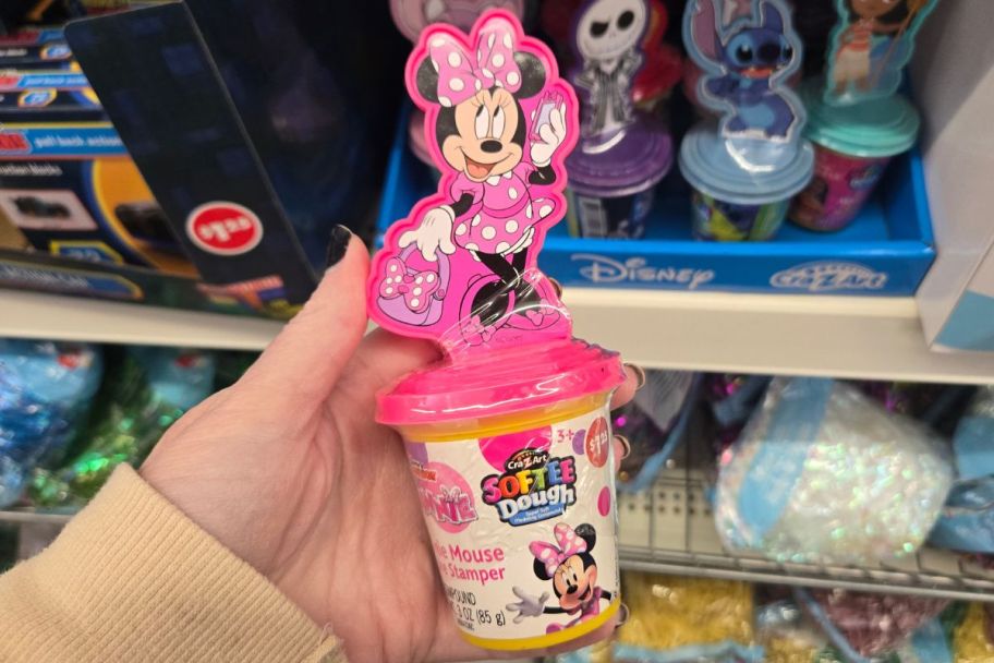 a womans hand holding a softee dough stamper