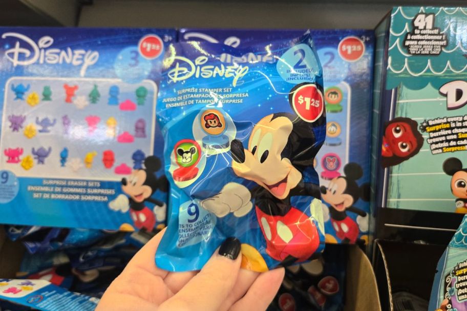 a womans hand holding a disney stamper 2 pack