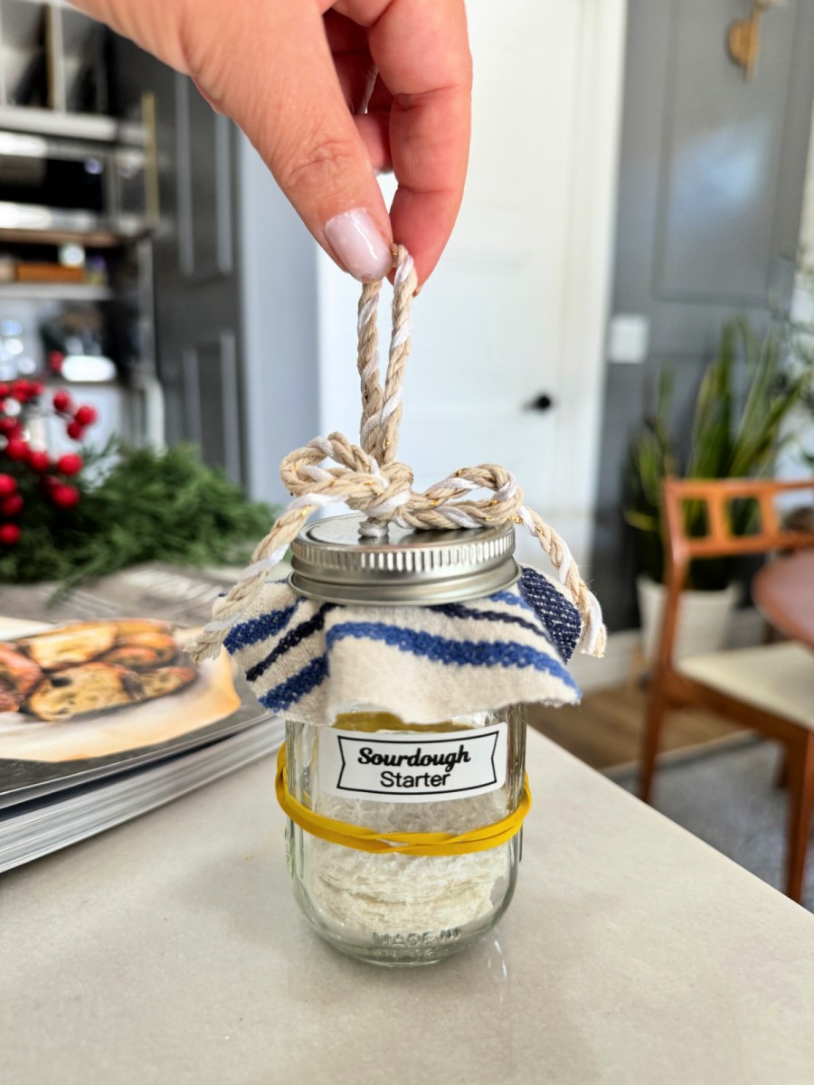holding a sourdough starter Christmas ornament 