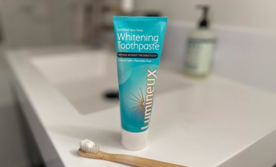 a single tube of lumineux toothpaste shown with toothbrush