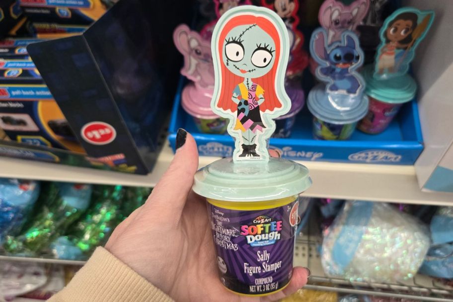 a womans hand holding a softee dough stamper