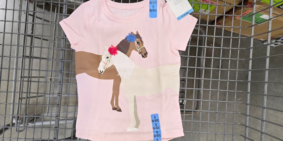 pink graphic tee with horses on it in shopping cart 