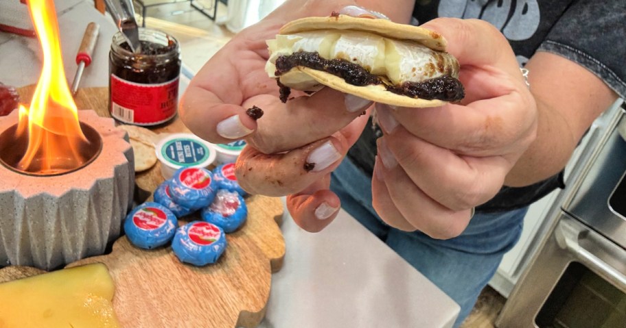 woman holding a brie and fig savory s'more