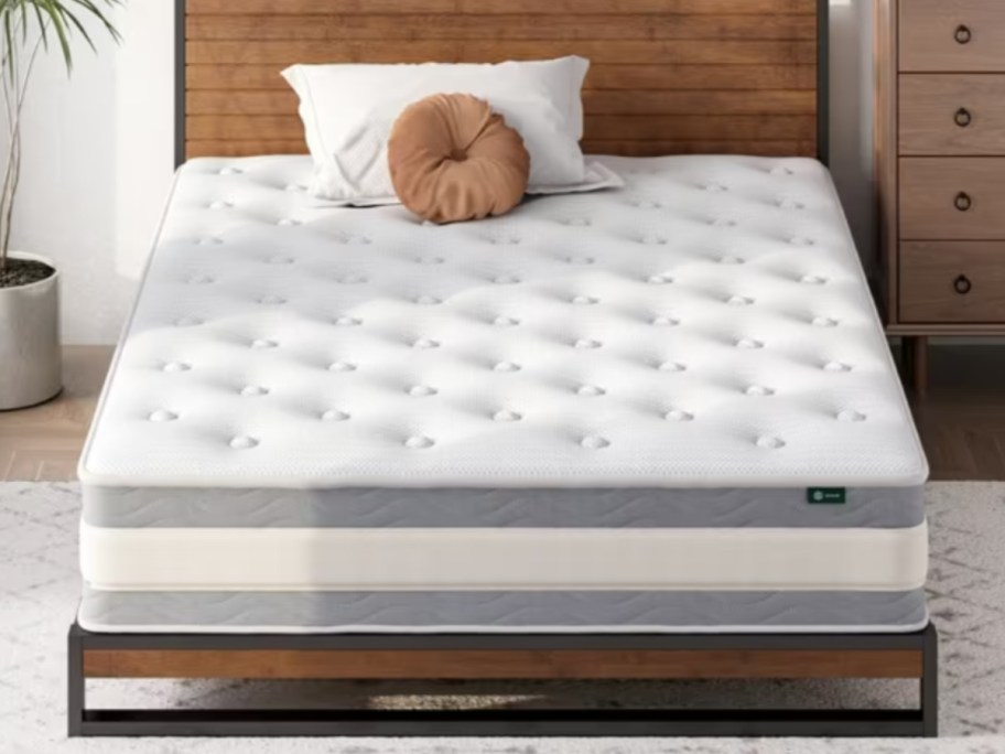 a white and grey memory foam mattress on wood platform bed in a bedroom