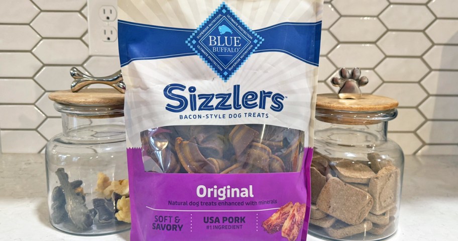 bag of Blue Buffalo dog treats on counter in front of treat jars
