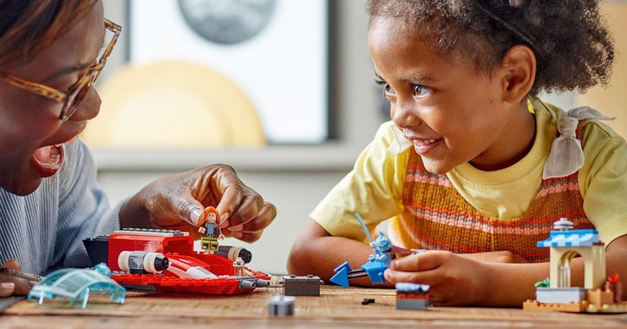 mom and daughter playing with LEGO Star Wars: Young Jedi Adventures The Crimson Firehawk set