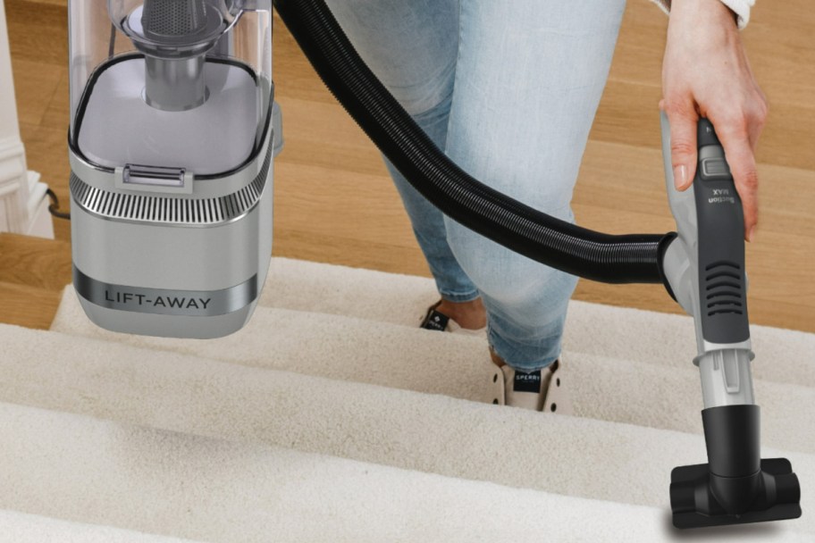 Shark upright vacuum with woman using the handle
