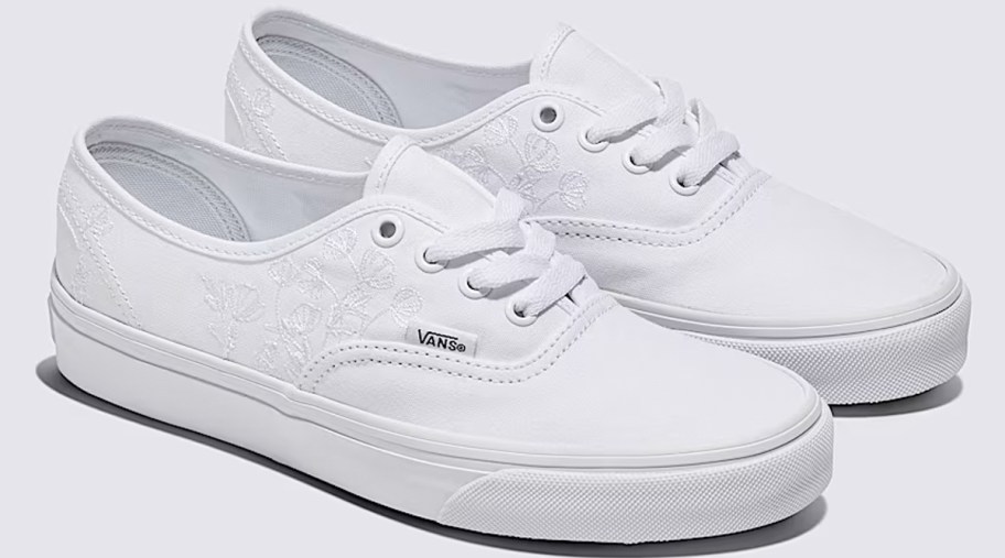 pair of white sneakers with floral embroidery 