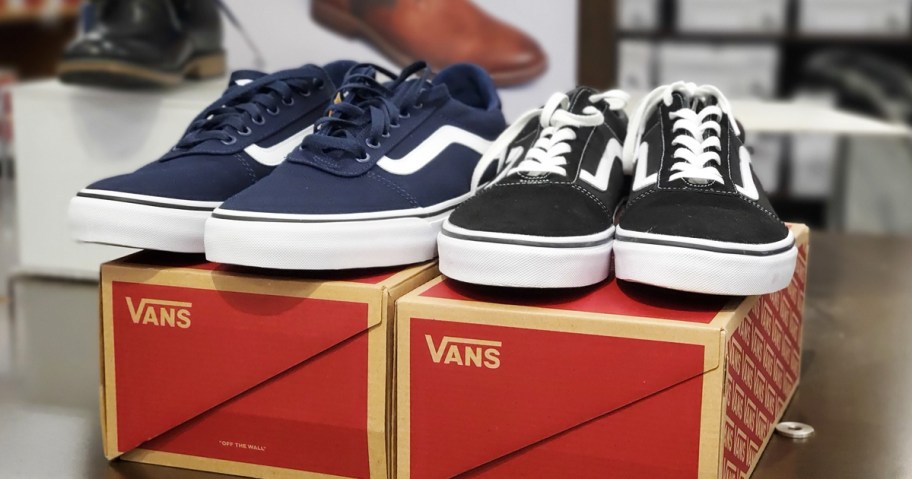 blue and black pairs of vans sneakers on top of their shoe boxes