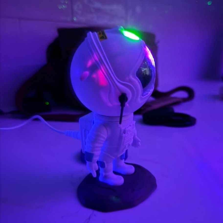an astronaut galaxy projector turned on and aimed at the ceiling