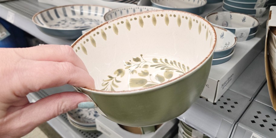 hand holding green cereal bowl 