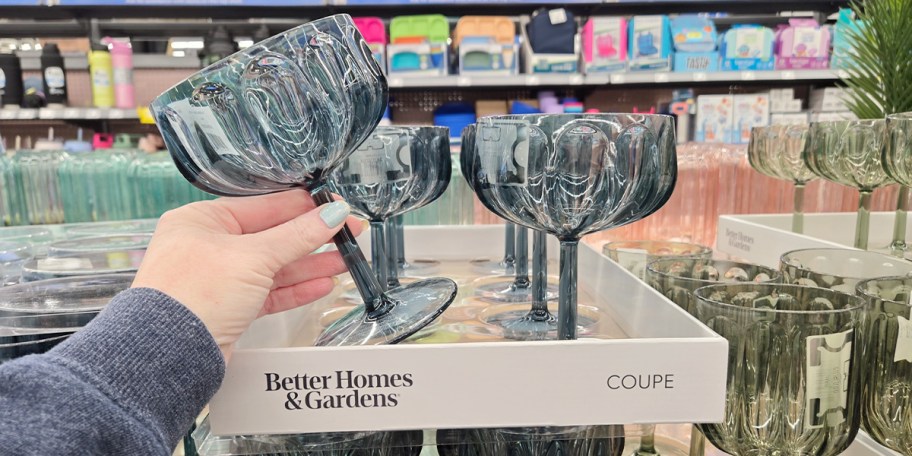hand holding blue coupe glass