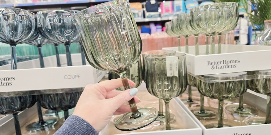 hand holding green wine glass
