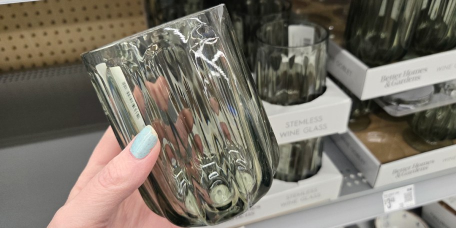 hand holding green wine glass 