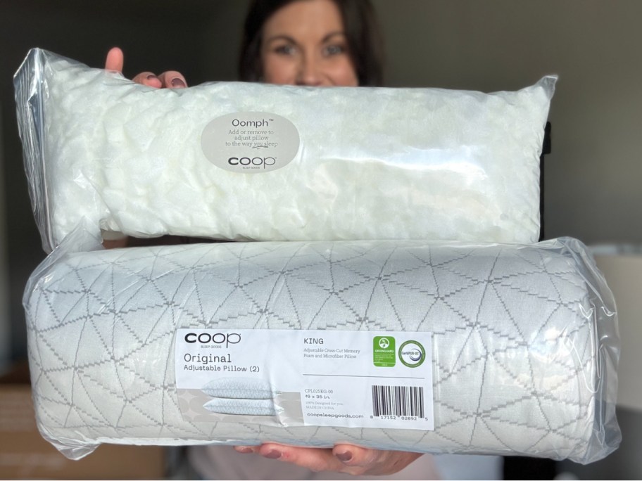 woman holding coop pillow and stuffing showing it to the camera