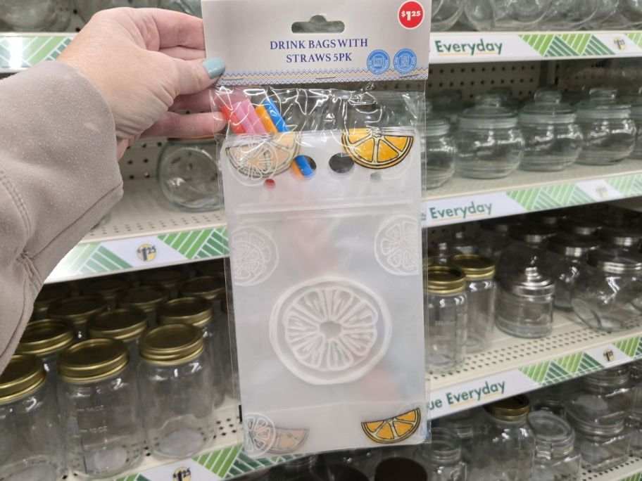 hand holding drink bags with straws package in store
