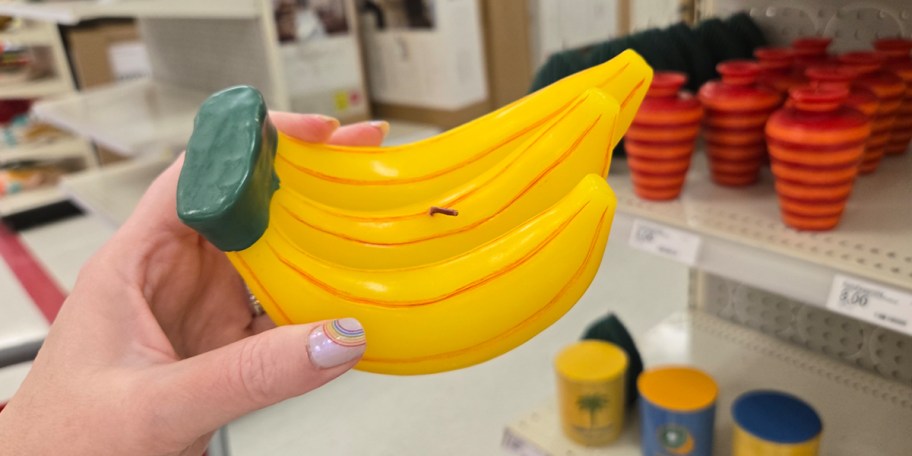 hand holding banana candle